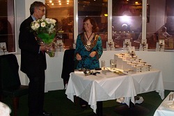 Mark presents Janet with flowers.